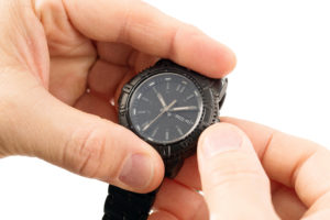 Photo of hands setting time on watch