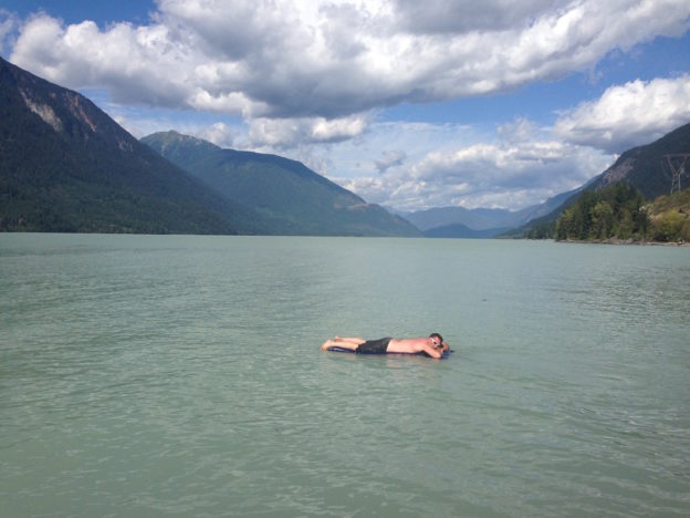 Photo of a person lying on an air mattress floating on a lake