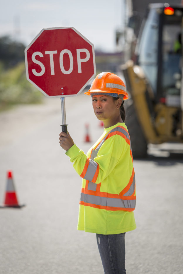 Photo of a TCP flagger direction traffic