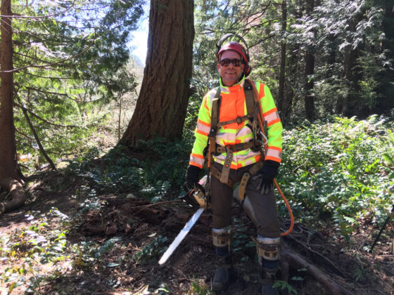 Photo of Shawn Michaels at work in the forest, wearing his logger’s gear