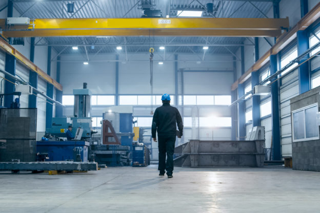 Photo of worker walking inside factory