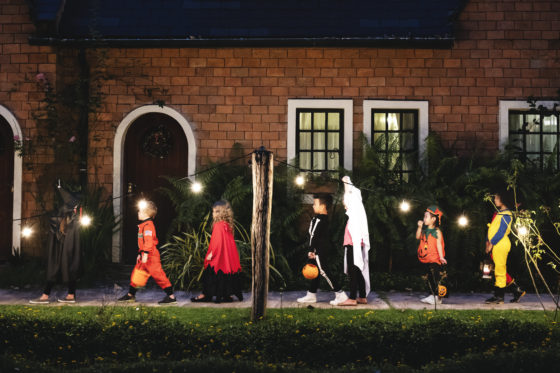 Photo of children in Halloween costumes out trick-or-treating