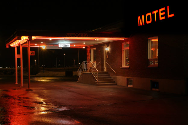 Photo of the outside of a motel office at night