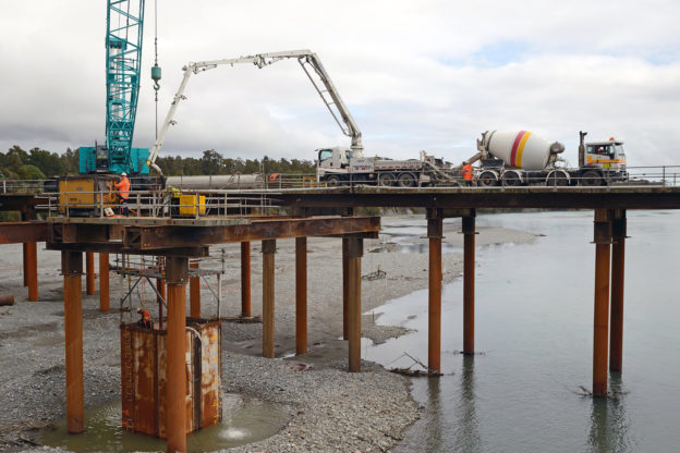 Photo of concrete pumper truck on bridge under construction