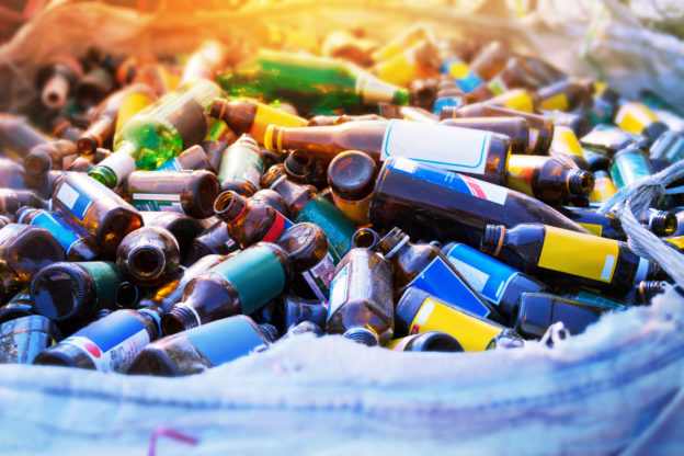 Photo of colourful empty, labelled bottles in a recycling bin