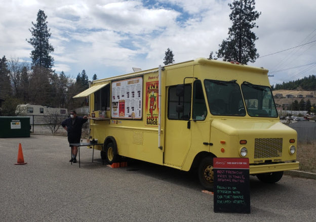 Photo of a bright yellow food truck supporting truck drivers