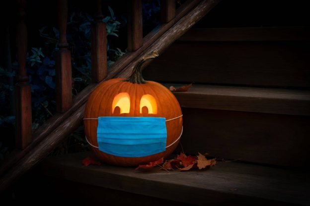 Photo of Halloween jack'o lantern with medical face mask