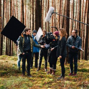 Photo of: Film crew filming movie scene in an outdoor location