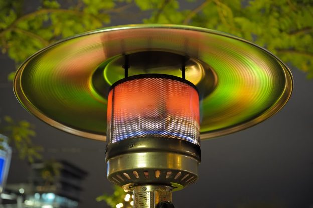 Photo of close-up of patio heater being used to keep people warm outdoors