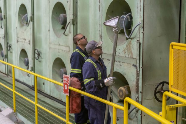 Photo of two workers at the pulp dryer area of the Domtar Kamloops Mill.