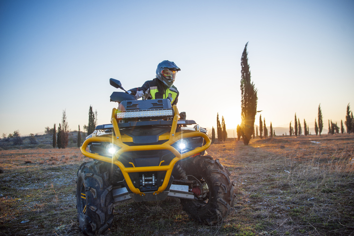 Photo of individual on ATV wearing PPE