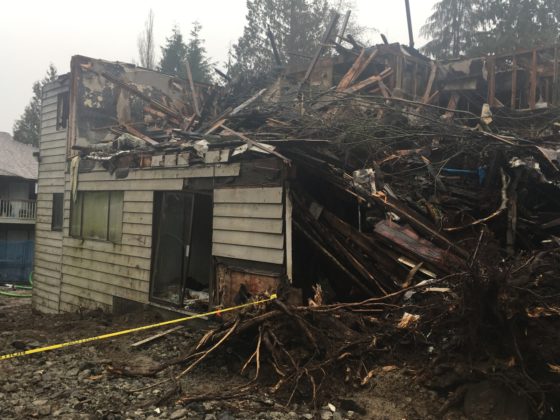 Photo of burned house with top story all caved in
