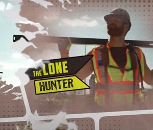 Photo of a man on a construction site wearing a high vis vest with The Lone Hunter written across the screen.