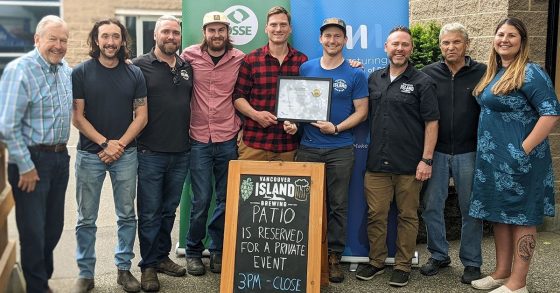 Photo of the Vancouver Island Brewing team holding their OSSE certification certificate.